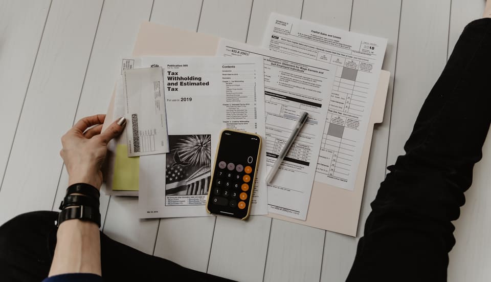 An individual reviewing their personal tax return at home